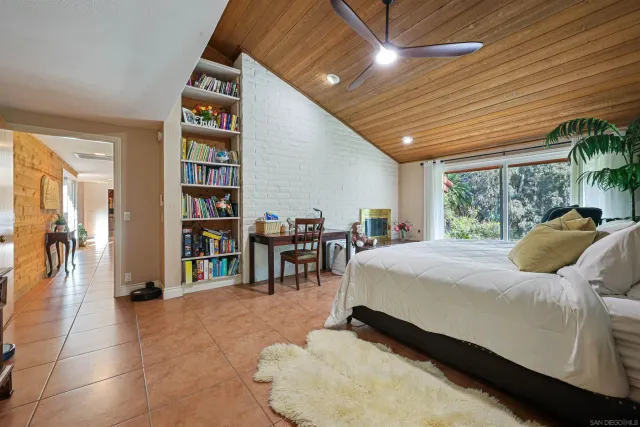 a bed room with a bed and a book shelf