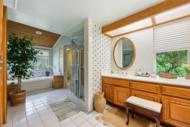 a bathroom with a sink a bathtub and a large window