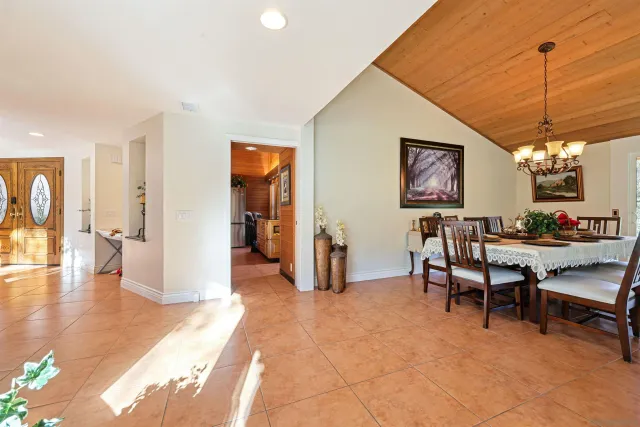 a view of a dining room with furniture wooden floor and chandelier
