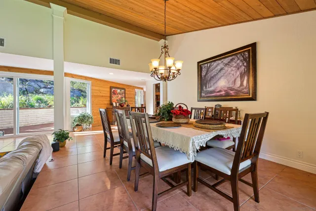 a view of a patio with table and chairs potted plants