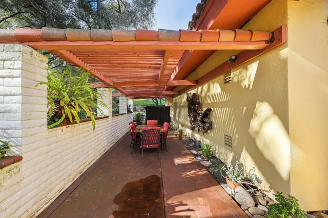 a view of a patio with table and chairs and potted plants