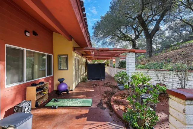 a view of a patio with table and chairs and potted plants
