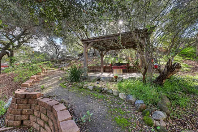 a view of a table and chairs under an umbrella