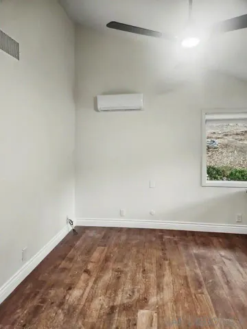 an entryway at livingroom with wooden floor