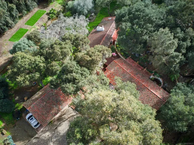 an aerial view of a house with a yard