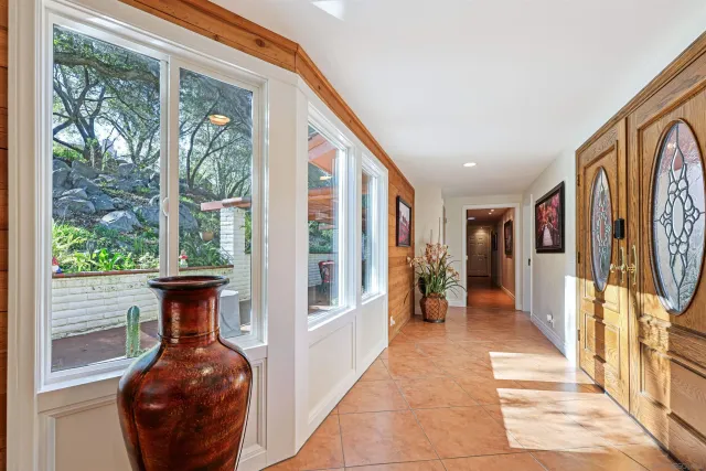 a hallway with furniture and a large window