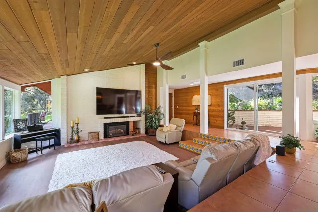 a bedroom with a bed and large windows