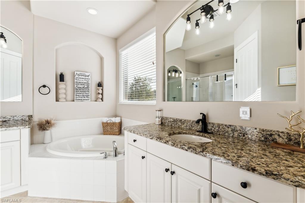 7821 Ashton Road Naples, FL 34113 - Photo 19 of 49 a bathroom with a granite countertop sink and a mirror