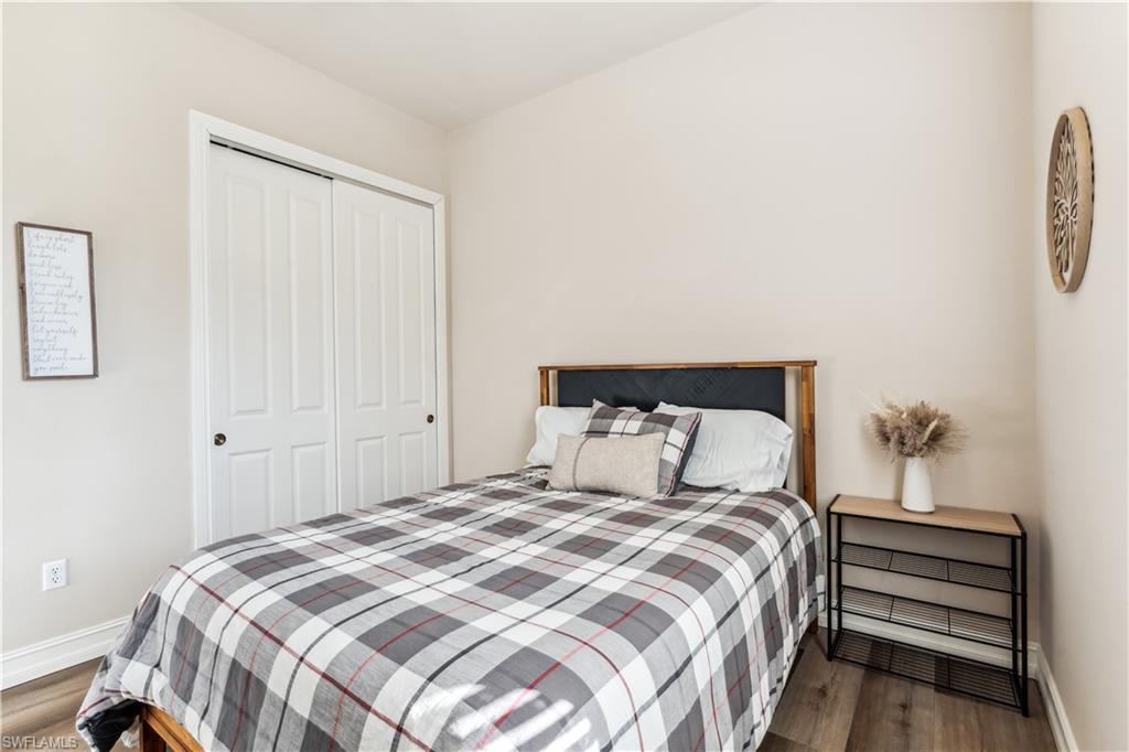 7821 Ashton Road Naples, FL 34113 - Photo 22 of 49 a bedroom with a bed and a closet