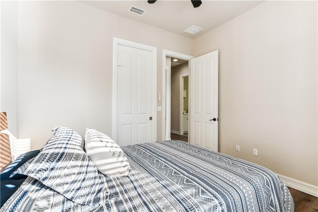 7821 Ashton Road Naples, FL 34113 - Photo 24 of 49 a bedroom with a bed and a window