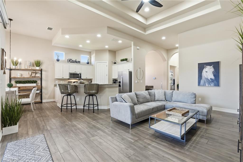 7821 Ashton Road Naples, FL 34113 - Photo 5 of 49 a living room with furniture and a wooden floor