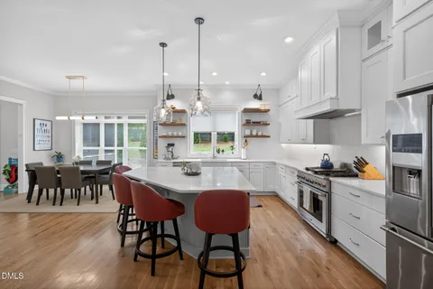 a kitchen with stainless steel appliances granite countertop a refrigerator and a sink
