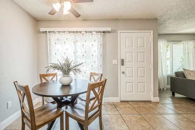 a view of a dining room with furniture and chandelier