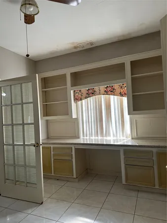 a kitchen with a window and a refrigerator