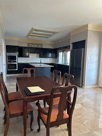 a kitchen with a table and chairs in it
