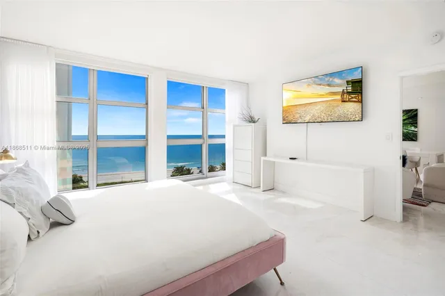 a bedroom with a bed and a flat screen tv