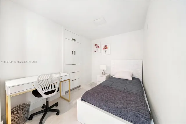 a bedroom with a bed and a workspace