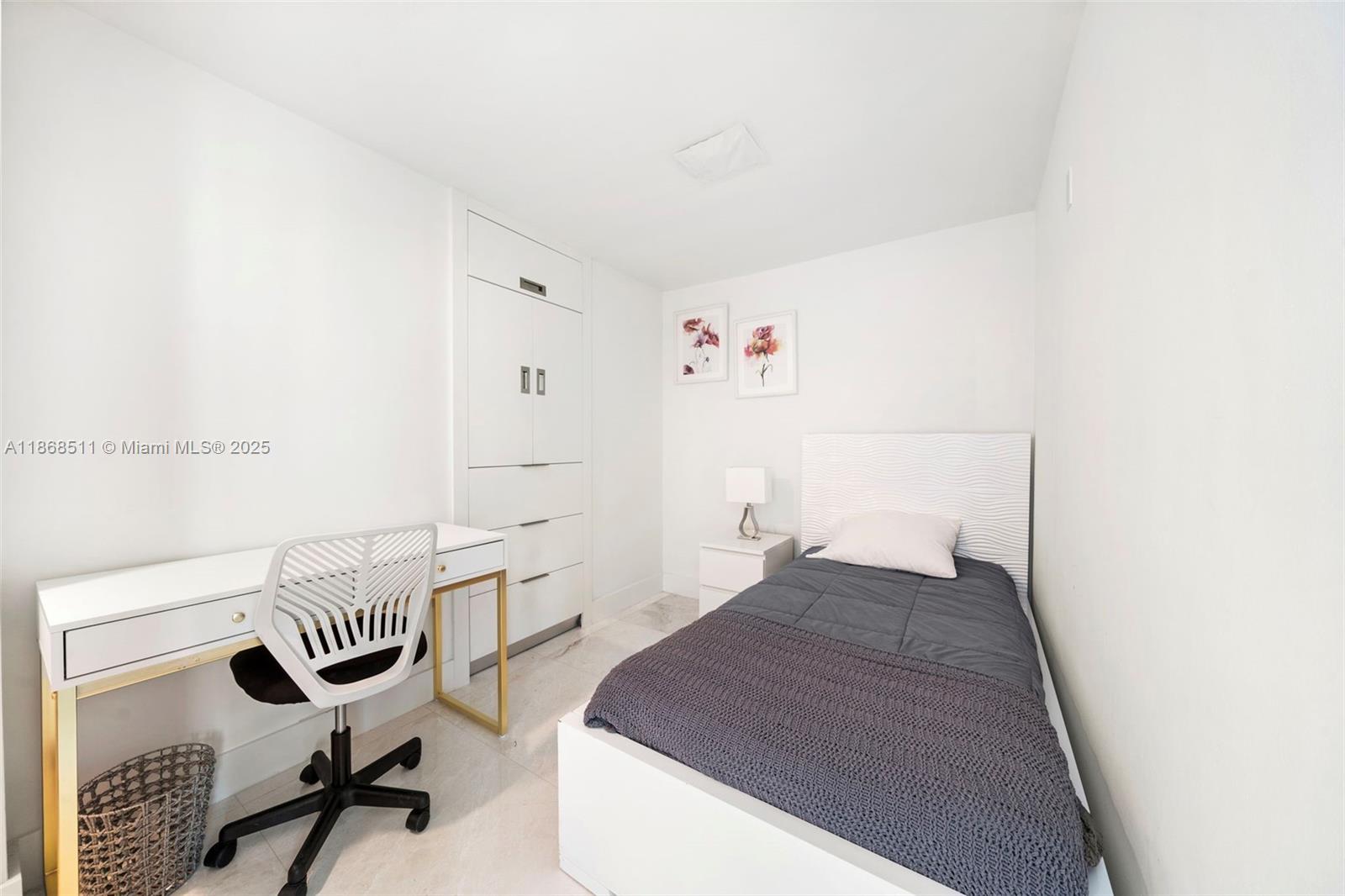5055 Collins Avenue, Unit 10G Miami Beach, FL 33140 - Photo 20 of 20 a bedroom with a bed and a workspace