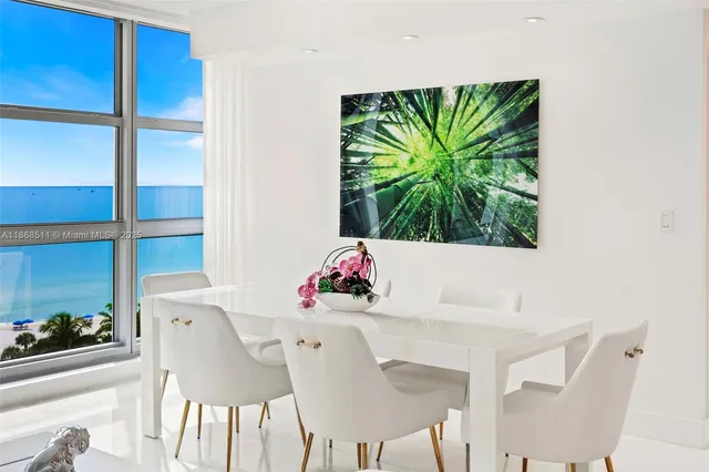 a view of a dining room with furniture and a potted plant