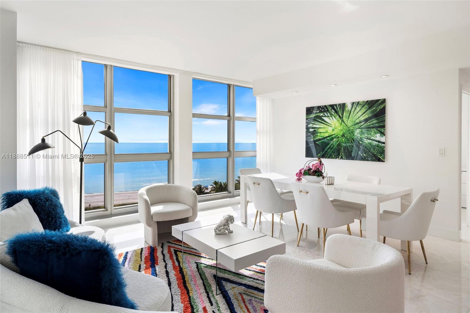 5055 Collins Avenue, Unit 10G Miami Beach, FL 33140 - Photo 9 of 20 a living room with furniture and a large window