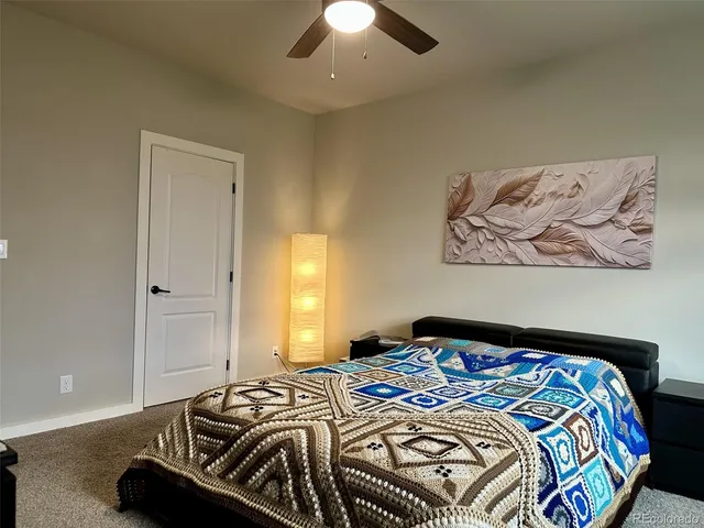 a bedroom with a bed and a painting on the wall