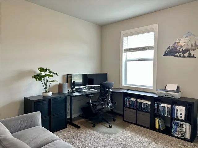 a view of a workspace with a window and a couch
