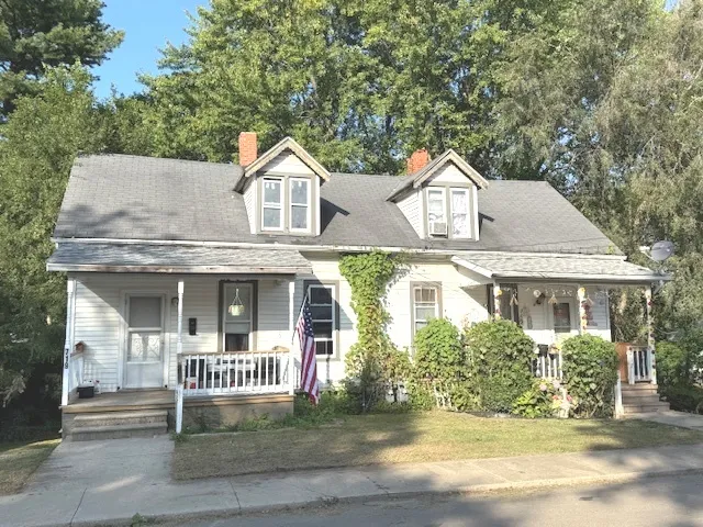 a front view of a house with a garden