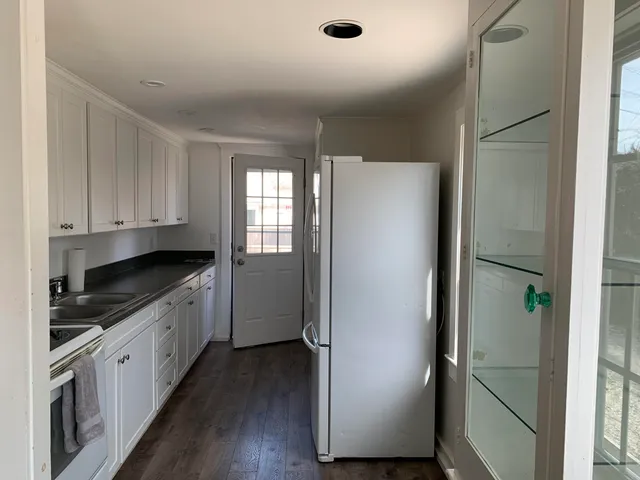 a kitchen with a refrigerator and a stove top oven