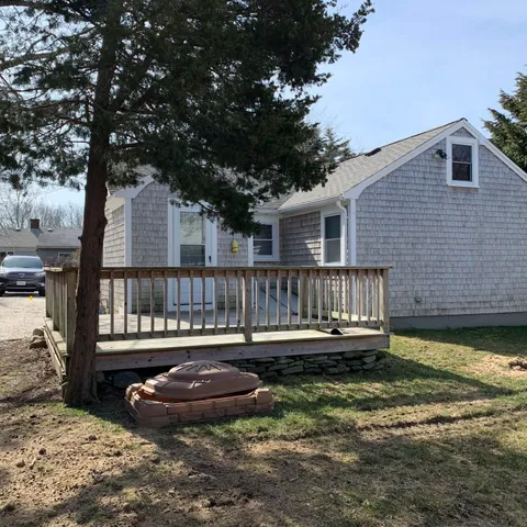 a view of a house with backyard and sitting area