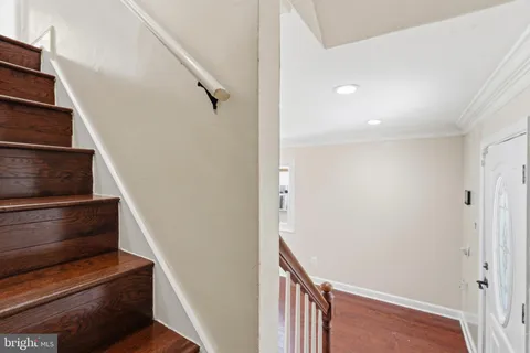 a view of entryway and hall with wooden floor