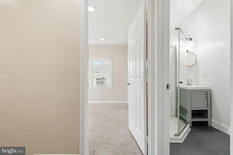 a view of a bathroom from a hallway