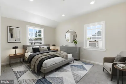 a bedroom with a large bed and a window