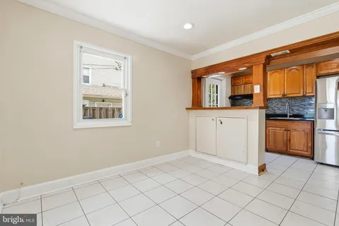 a view of a kitchen with white cabinets