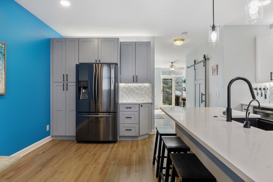 26 East 14th Place, Unit 15W Chicago, IL 60605 - Photo 12 of 36 a kitchen with stainless steel appliances granite countertop a refrigerator and a stove top oven