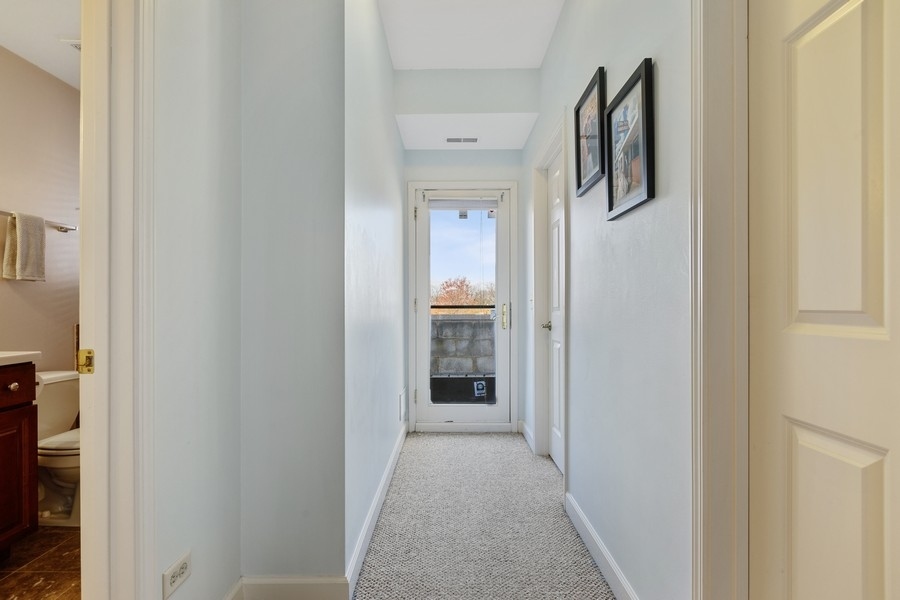 26 East 14th Place, Unit 15W Chicago, IL 60605 - Photo 25 of 36 a view of a hallway with wooden floor and a living room