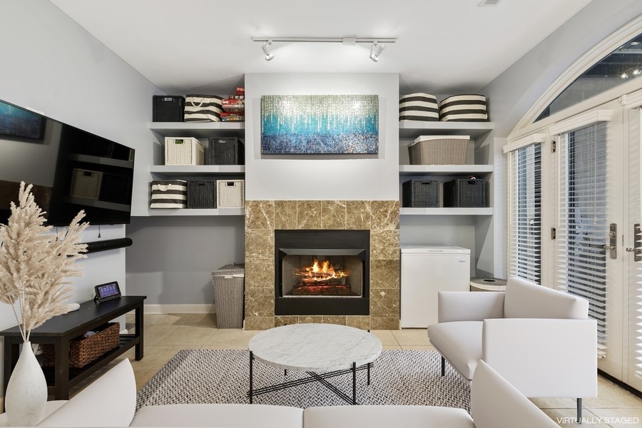 26 East 14th Place, Unit 15W Chicago, IL 60605 - Photo 4 of 36 a living room with furniture a flat screen tv and a fireplace