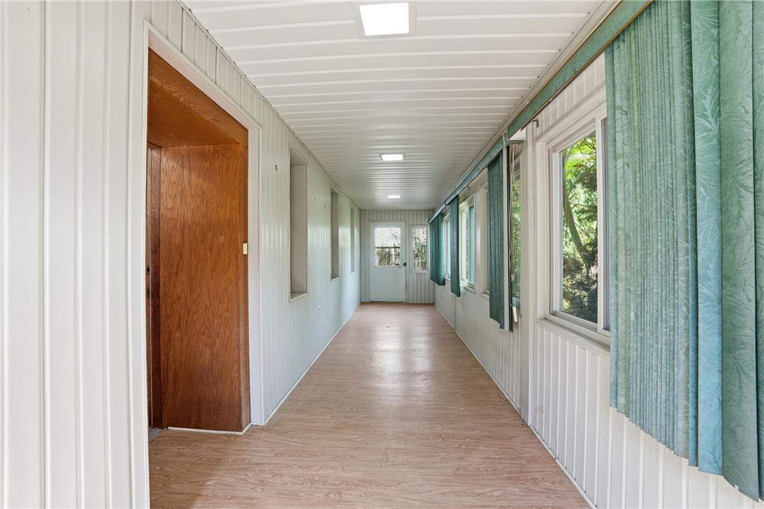 6271 Batman Road Zionsville, PA 18092 - Photo 46 of 100 A long, enclosed hallway offers abundant natural light and provides a clear pathway.