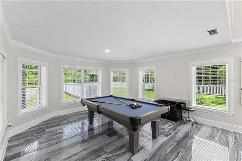 a living room with furniture tv and a window