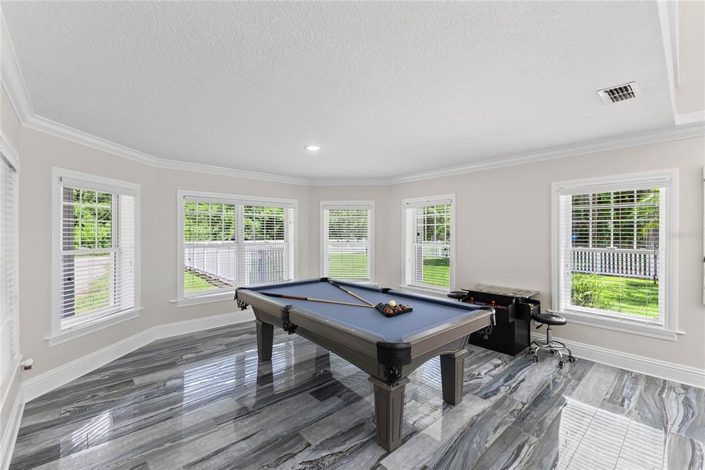 3663 Berger Road Lutz, FL 33548 - Photo 11 of 65 a view of a workspace with a window and wooden floor