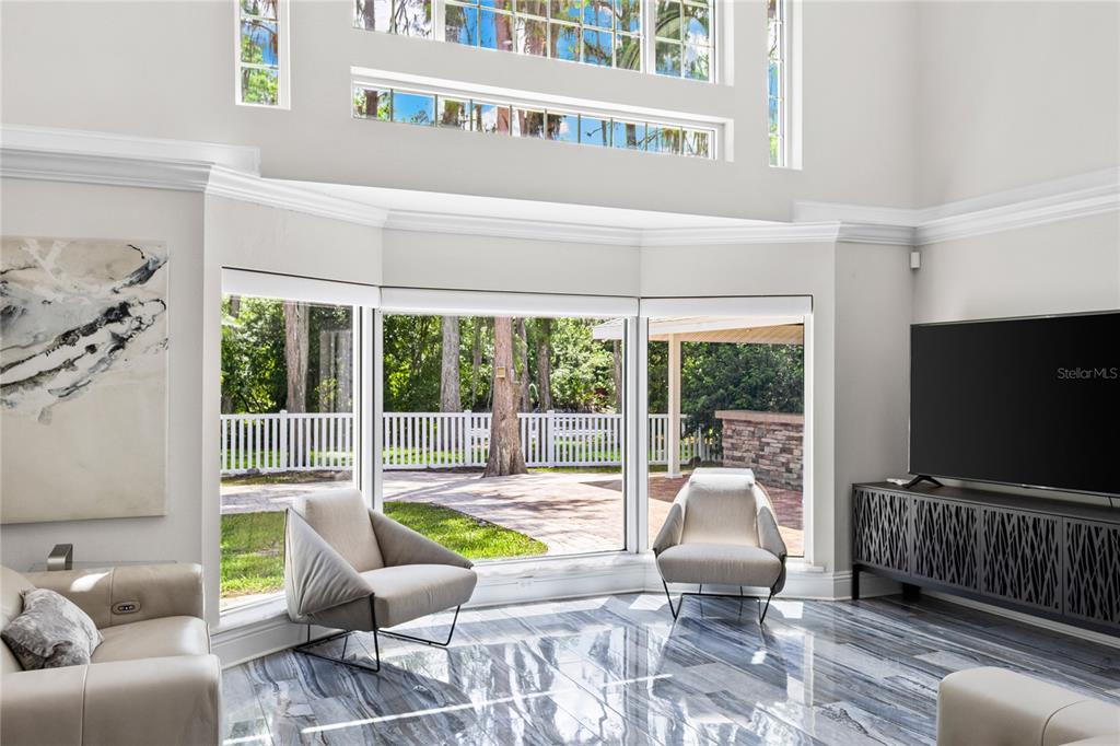 3663 Berger Road Lutz, FL 33548 - Photo 12 of 65 a living room with furniture tv and a window