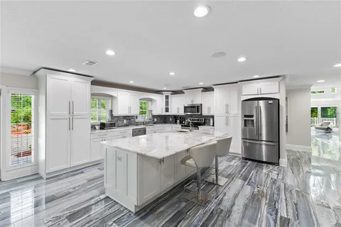 a kitchen with a sink stove top oven and microwave