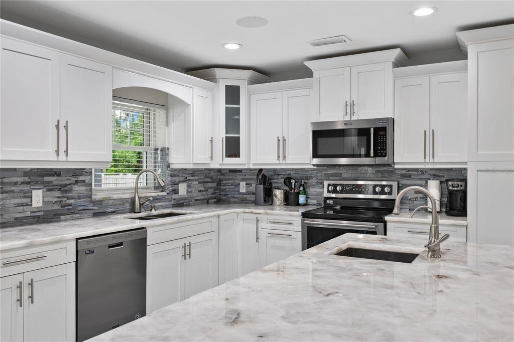 3663 Berger Road Lutz, FL 33548 - Photo 17 of 65 a kitchen with a sink stove top oven and microwave