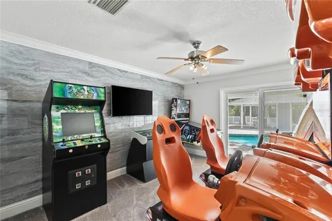 a living room with furniture large window and wooden floor