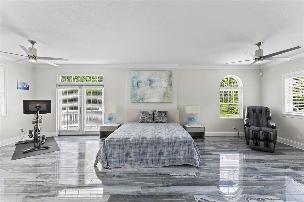 3663 Berger Road Lutz, FL 33548 - Photo 29 of 65 a bedroom with a bed and wooden floor