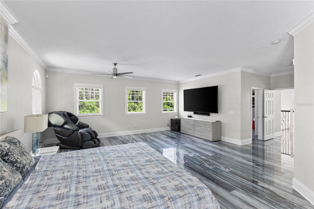 3663 Berger Road Lutz, FL 33548 - Photo 31 of 65 a living room with furniture a flat screen tv and a window