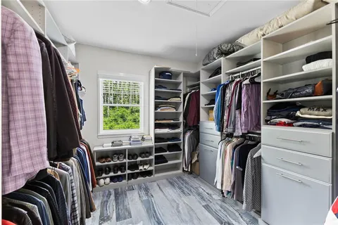 a living room with furniture a window and a flat screen tv