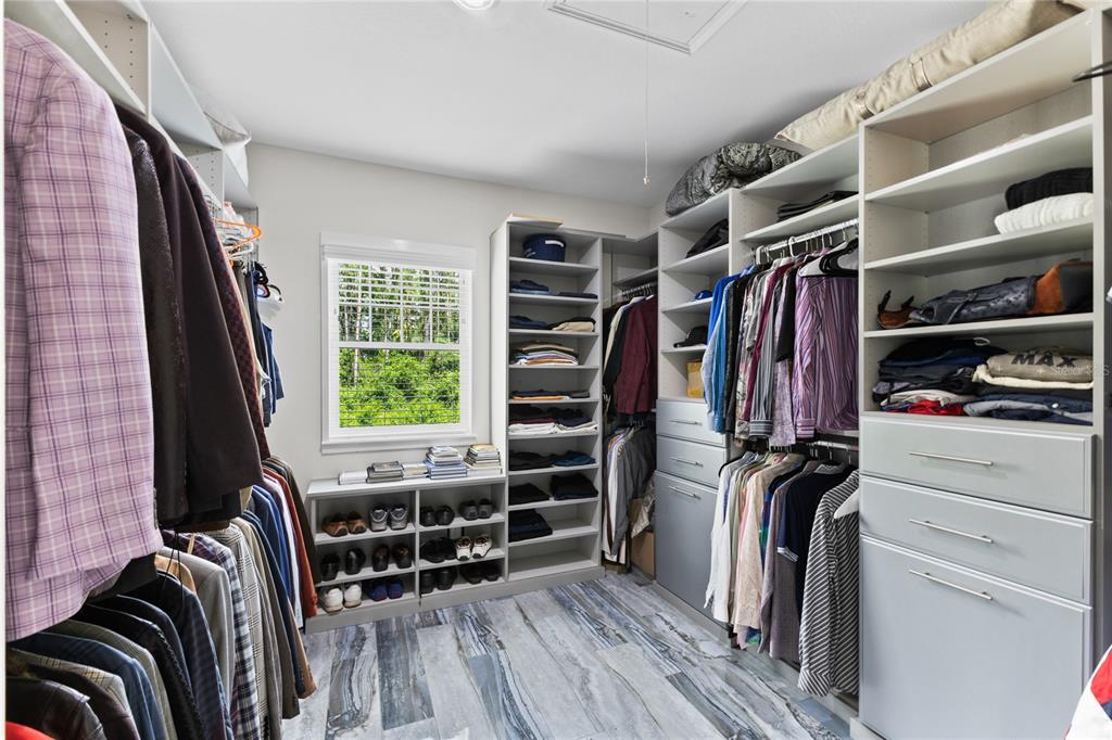 3663 Berger Road Lutz, FL 33548 - Photo 34 of 65 a view of walk in closet with clothes and shoes