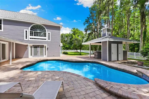 a view of pool with deck yard and outdoor seating