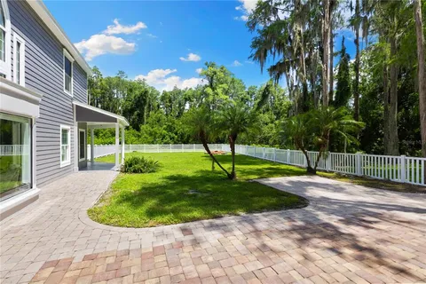 an aerial view of a house with pool lake view and mountain view