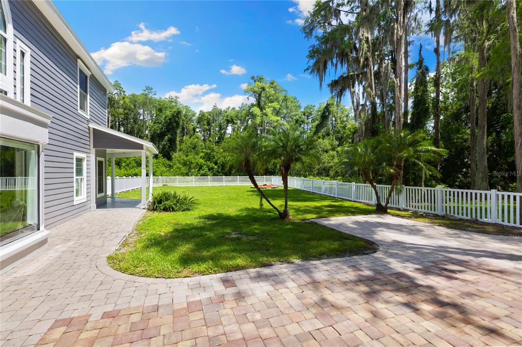 3663 Berger Road Lutz, FL 33548 - Photo 50 of 65 a view of a backyard with a garden